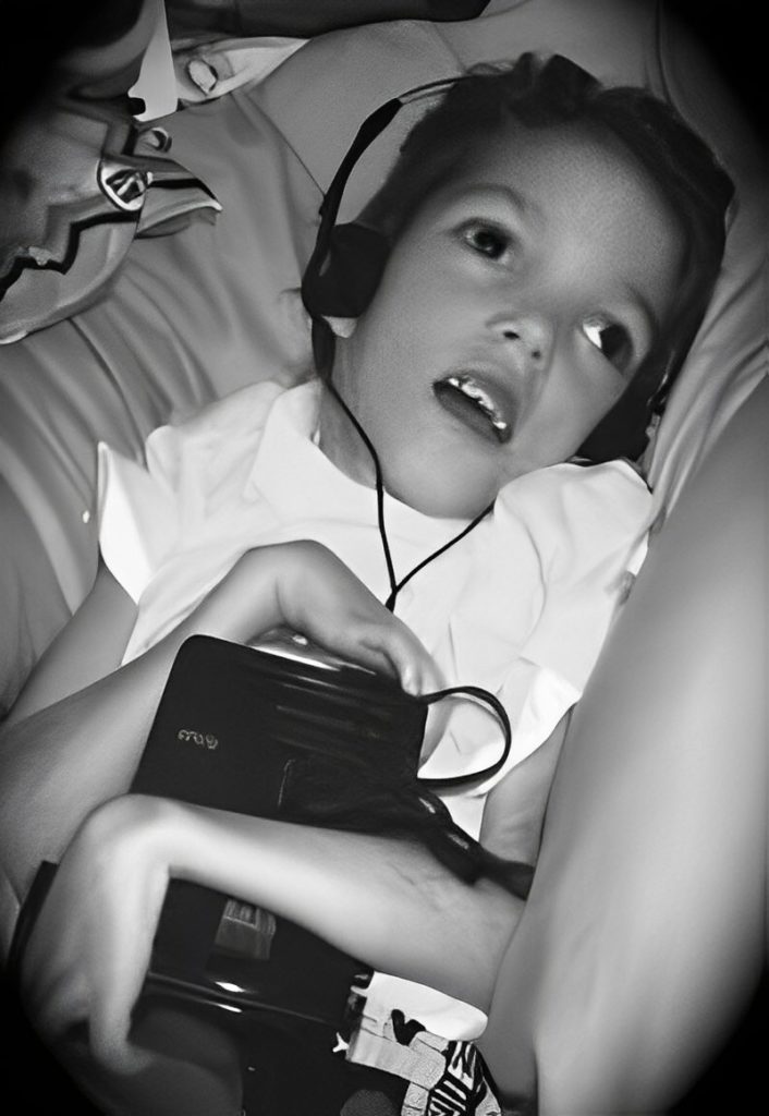 A young child resting with headphones